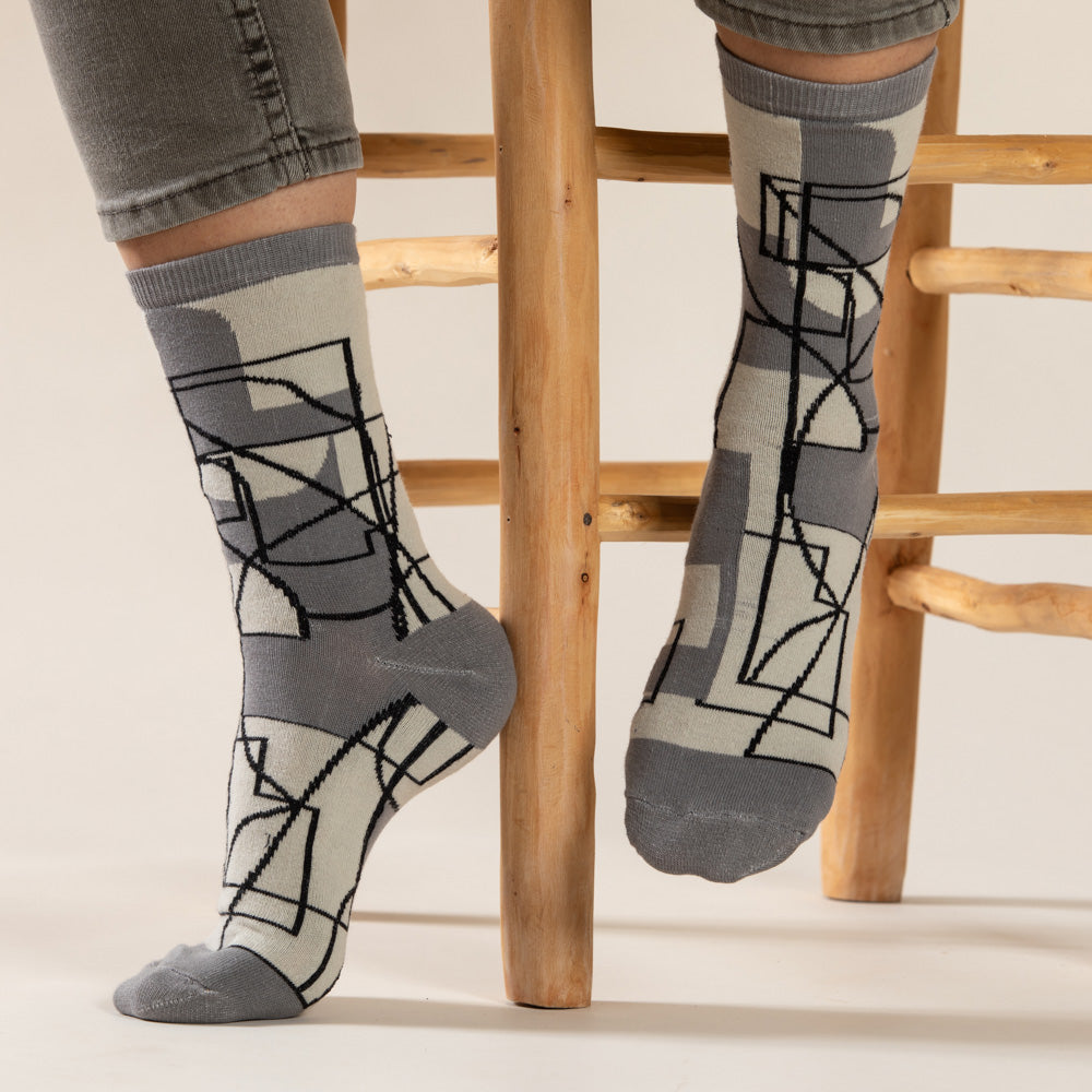 Elevate your everyday style with our elegant unisex socks designed by the KaRiniTi Studio. These monochromatic socks blend clean lines with subtle, refined details, echoing our passion for precision and typography. Perfect for any outfit, each pair brings a unique design element inspired by our studio's signature obsession with structured layouts and minimalist aesthetics.
Cutout: Inspired by our silkscreen prints, this design layers typography, numbers, and contour lines, forming a bold new composition. I