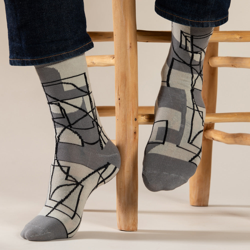 Elevate your everyday style with our elegant unisex socks designed by the KaRiniTi Studio. These monochromatic socks blend clean lines with subtle, refined details, echoing our passion for precision and typography. Perfect for any outfit, each pair brings a unique design element inspired by our studio's signature obsession with structured layouts and minimalist aesthetics.
Cutout: Inspired by our silkscreen prints, this design layers typography, numbers, and contour lines, forming a bold new composition. I