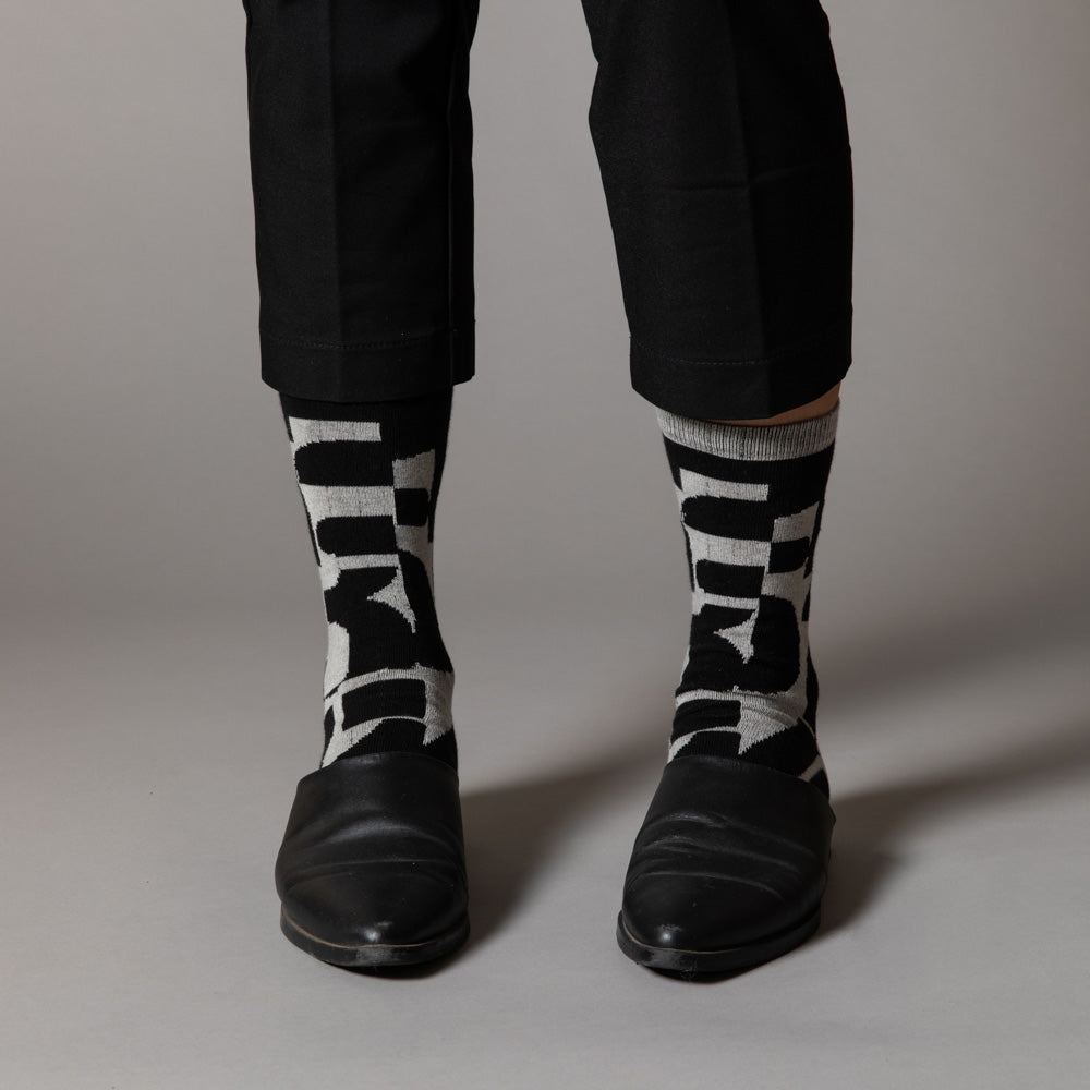 Elevate your everyday style with our elegant unisex socks designed by the KaRiniTi Studio. These monochromatic socks blend clean lines with subtle, refined details, echoing our passion for precision and typography. Perfect for any outfit, each pair brings a unique design element inspired by our studio's signature obsession with structured layouts and minimalist aesthetics.
- Numbers: Featuring bold, oversized numbers in various cuts, this design draws inspiration from KaRiniTi's signature wrapping paper. T