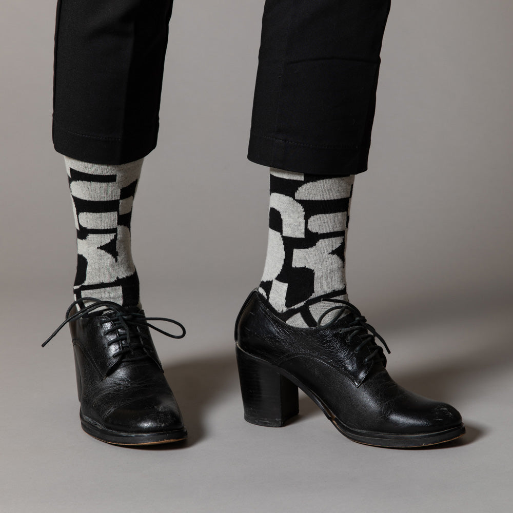 Elevate your everyday style with our elegant unisex socks designed by the KaRiniTi Studio. These monochromatic socks blend clean lines with subtle, refined details, echoing our passion for precision and typography. Perfect for any outfit, each pair brings a unique design element inspired by our studio's signature obsession with structured layouts and minimalist aesthetics.
- Numbers: Featuring bold, oversized numbers in various cuts, this design draws inspiration from KaRiniTi's signature wrapping paper. T