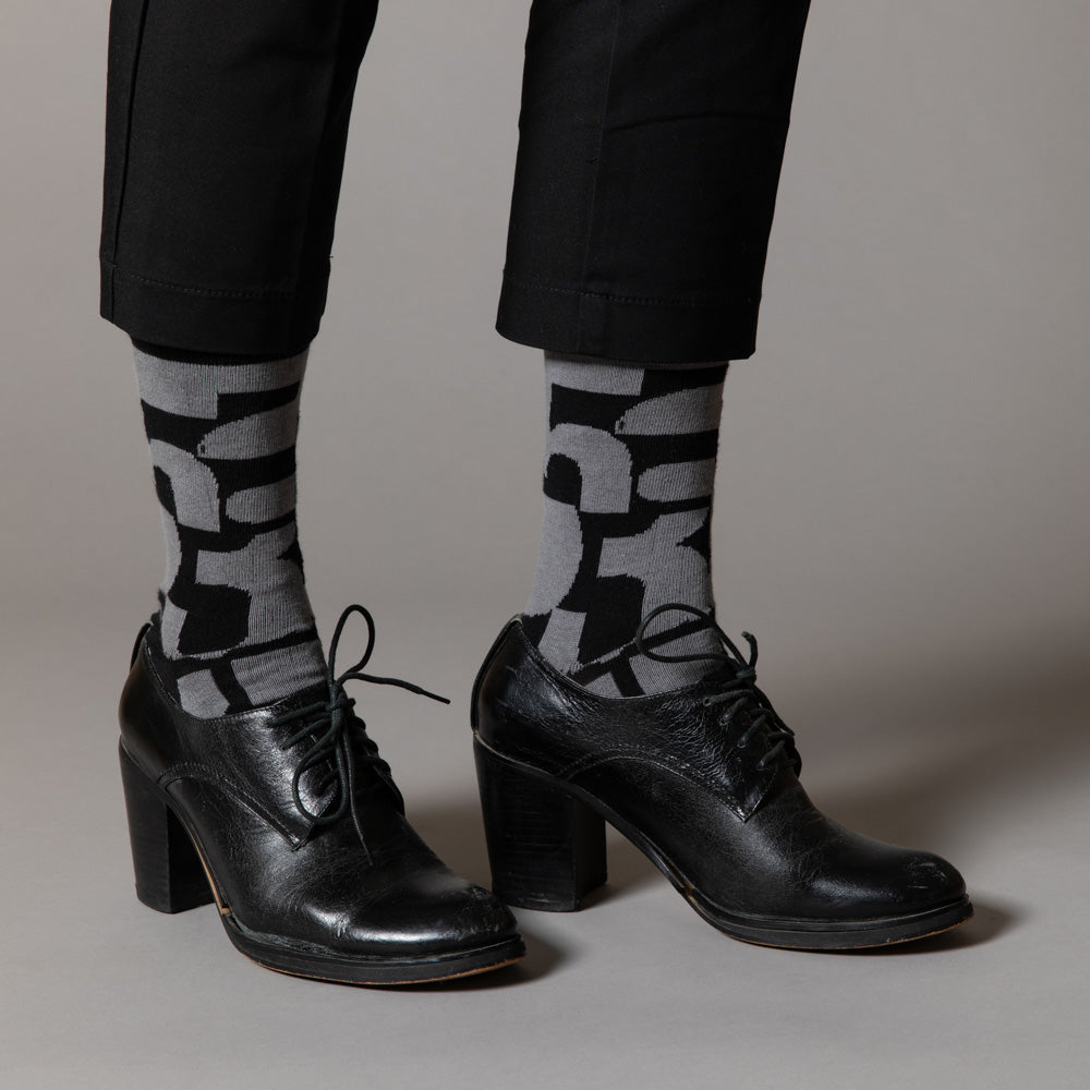 Elevate your everyday style with our elegant unisex socks designed by the KaRiniTi Studio. These monochromatic socks blend clean lines with subtle, refined details, echoing our passion for precision and typography. Perfect for any outfit, each pair brings a unique design element inspired by our studio's signature obsession with structured layouts and minimalist aesthetics.
- Numbers: Featuring bold, oversized numbers in various cuts, this design draws inspiration from KaRiniTi's signature wrapping paper. T