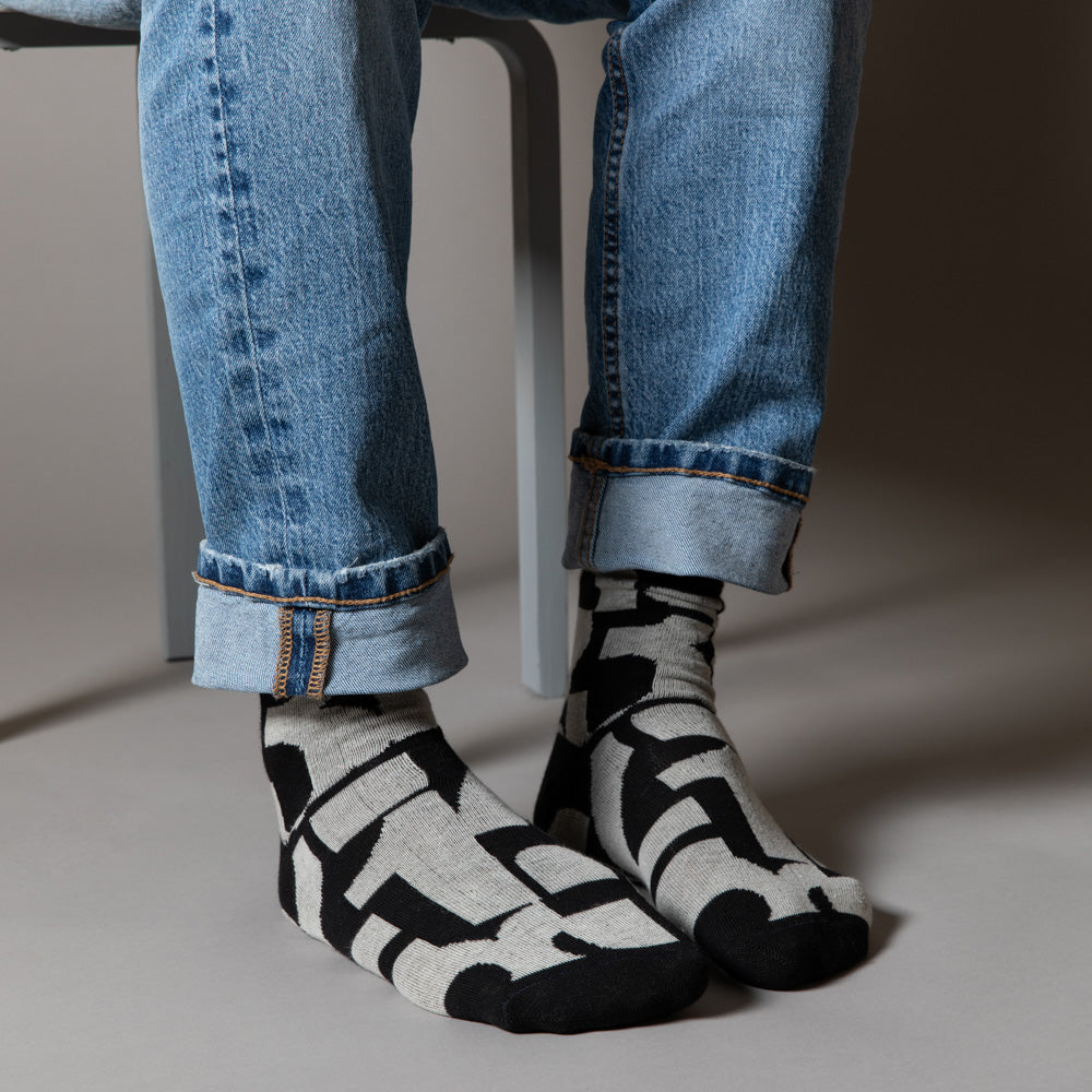 Elevate your everyday style with our elegant unisex socks designed by the KaRiniTi Studio. These monochromatic socks blend clean lines with subtle, refined details, echoing our passion for precision and typography. Perfect for any outfit, each pair brings a unique design element inspired by our studio's signature obsession with structured layouts and minimalist aesthetics.
- Numbers: Featuring bold, oversized numbers in various cuts, this design draws inspiration from KaRiniTi's signature wrapping paper. T
