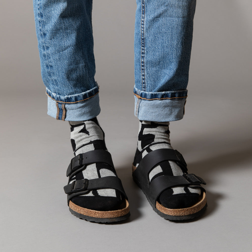 Elevate your everyday style with our elegant unisex socks designed by the KaRiniTi Studio. These monochromatic socks blend clean lines with subtle, refined details, echoing our passion for precision and typography. Perfect for any outfit, each pair brings a unique design element inspired by our studio's signature obsession with structured layouts and minimalist aesthetics.
- Numbers: Featuring bold, oversized numbers in various cuts, this design draws inspiration from KaRiniTi's signature wrapping paper. T
