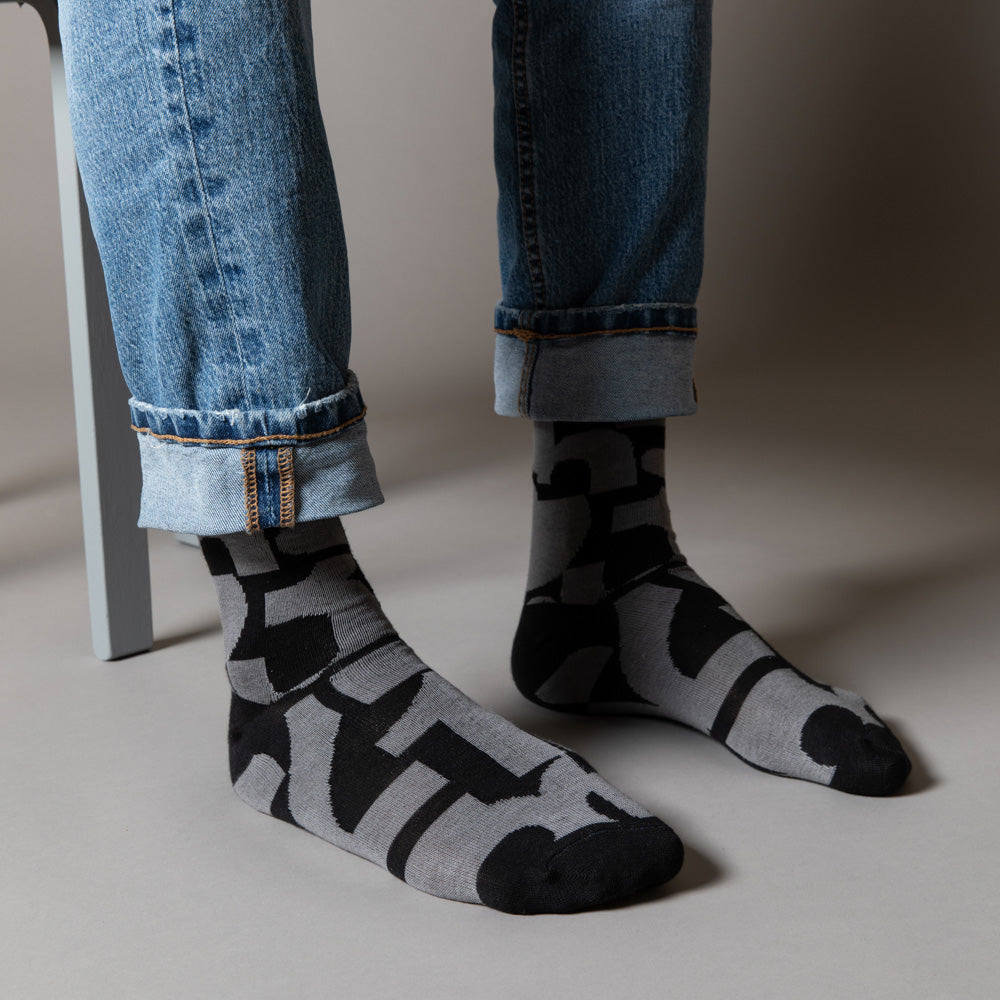 Elevate your everyday style with our elegant unisex socks designed by the KaRiniTi Studio. These monochromatic socks blend clean lines with subtle, refined details, echoing our passion for precision and typography. Perfect for any outfit, each pair brings a unique design element inspired by our studio's signature obsession with structured layouts and minimalist aesthetics.
- Numbers: Featuring bold, oversized numbers in various cuts, this design draws inspiration from KaRiniTi's signature wrapping paper. T