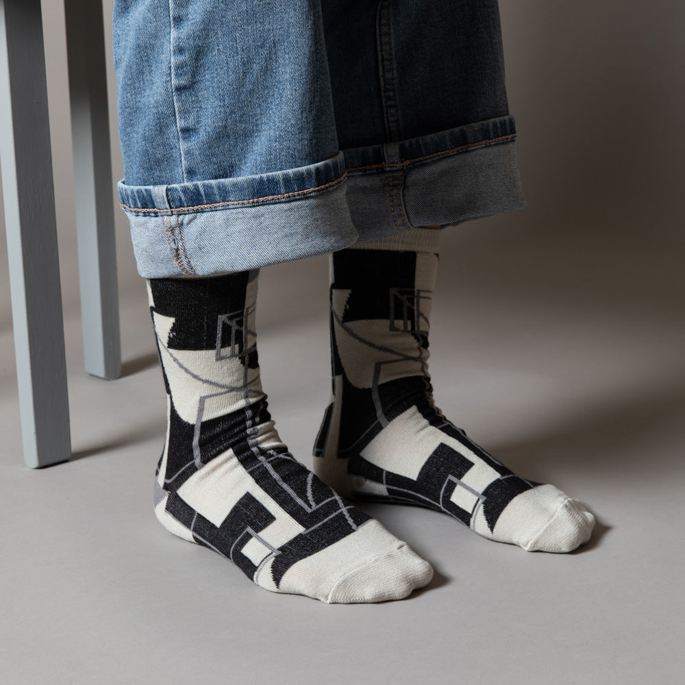 Elevate your everyday style with our elegant unisex socks designed by the KaRiniTi Studio. These monochromatic socks blend clean lines with subtle, refined details, echoing our passion for precision and typography. Perfect for any outfit, each pair brings a unique design element inspired by our studio's signature obsession with structured layouts and minimalist aesthetics.
Cutout: Inspired by our silkscreen prints, this design layers typography, numbers, and contour lines, forming a bold new composition. I
