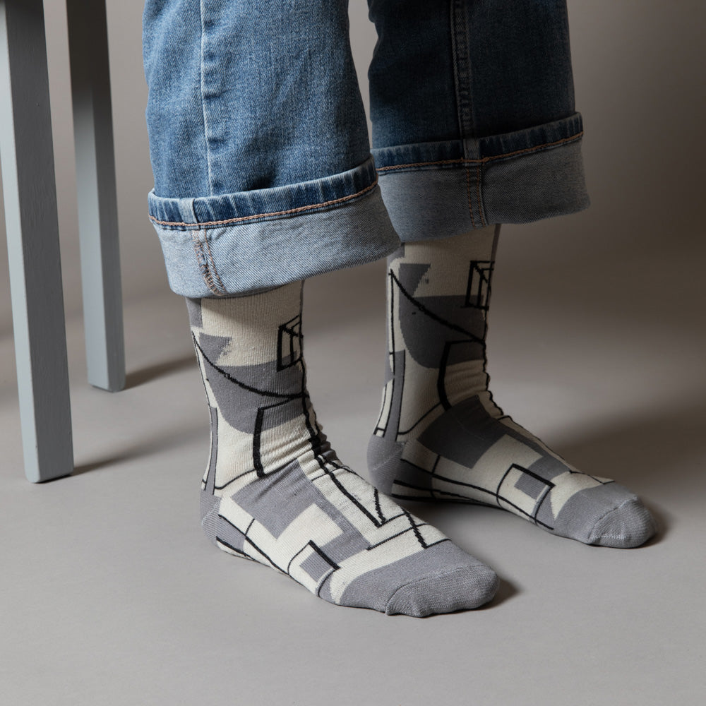 Elevate your everyday style with our elegant unisex socks designed by the KaRiniTi Studio. These monochromatic socks blend clean lines with subtle, refined details, echoing our passion for precision and typography. Perfect for any outfit, each pair brings a unique design element inspired by our studio's signature obsession with structured layouts and minimalist aesthetics.
Cutout: Inspired by our silkscreen prints, this design layers typography, numbers, and contour lines, forming a bold new composition. I