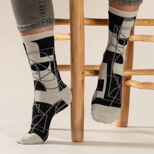 Elevate your everyday style with our elegant unisex socks designed by the KaRiniTi Studio. These monochromatic socks blend clean lines with subtle, refined details, echoing our passion for precision and typography. Perfect for any outfit, each pair brings a unique design element inspired by our studio's signature obsession with structured layouts and minimalist aesthetics.

Cutout: Inspired by our silkscreen prints, this design layers typography, numbers, and contour lines, forming a bold new composition. I