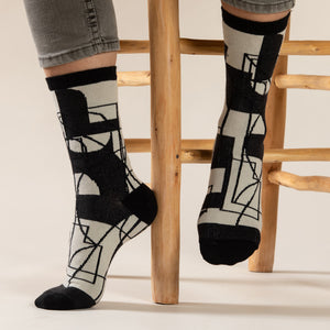 Elevate your everyday style with our elegant unisex socks designed by the KaRiniTi Studio. These monochromatic socks blend clean lines with subtle, refined details, echoing our passion for precision and typography. Perfect for any outfit, each pair brings a unique design element inspired by our studio's signature obsession with structured layouts and minimalist aesthetics.

Cutout: Inspired by our silkscreen prints, this design layers typography, numbers, and contour lines, forming a bold new composition. I