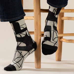 Elevate your everyday style with our elegant unisex socks designed by the KaRiniTi Studio. These monochromatic socks blend clean lines with subtle, refined details, echoing our passion for precision and typography. Perfect for any outfit, each pair brings a unique design element inspired by our studio's signature obsession with structured layouts and minimalist aesthetics.

Cutout: Inspired by our silkscreen prints, this design layers typography, numbers, and contour lines, forming a bold new composition. I