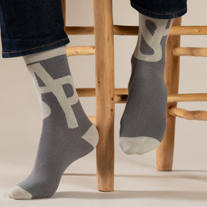 Elevate your everyday style with our elegant unisex socks designed by the KaRiniTi Studio. These monochromatic socks blend clean lines with subtle, refined details, echoing our passion for precision and typography. Perfect for any outfit, each pair brings a unique design element inspired by our studio's signature obsession with structured layouts and minimalist aesthetics.

ASAP: Make a statement with the ASAP socks, reflecting the dynamic energy of KaRiniTi's ASAP notebook. These socks are your fast track 