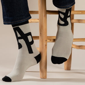 Elevate your everyday style with our elegant unisex socks designed by the KaRiniTi Studio. These monochromatic socks blend clean lines with subtle, refined details, echoing our passion for precision and typography. Perfect for any outfit, each pair brings a unique design element inspired by our studio's signature obsession with structured layouts and minimalist aesthetics.

ASAP: Make a statement with the ASAP socks, reflecting the dynamic energy of KaRiniTi's ASAP notebook. These socks are your fast track 