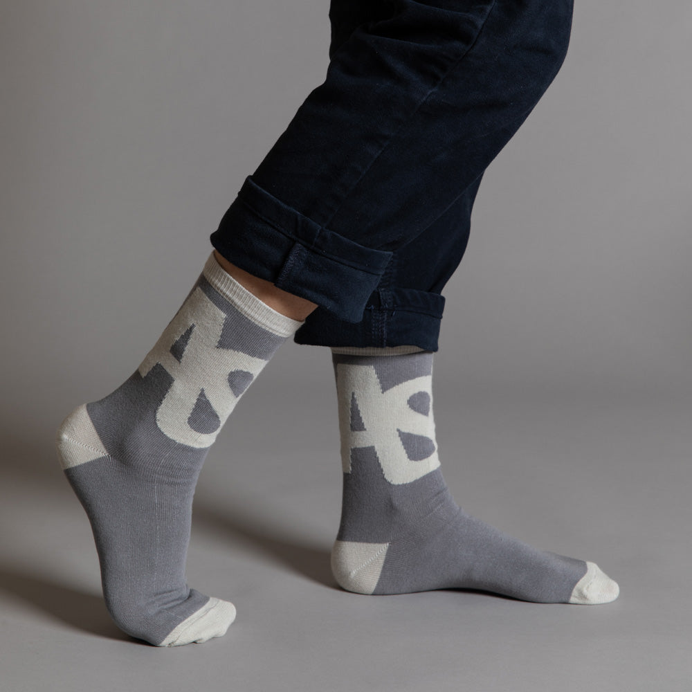 Elevate your everyday style with our elegant unisex socks designed by the KaRiniTi Studio. These monochromatic socks blend clean lines with subtle, refined details, echoing our passion for precision and typography. Perfect for any outfit, each pair brings a unique design element inspired by our studio's signature obsession with structured layouts and minimalist aesthetics.

ASAP: Make a statement with the ASAP socks, reflecting the dynamic energy of KaRiniTi's ASAP notebook. These socks are your fast track 