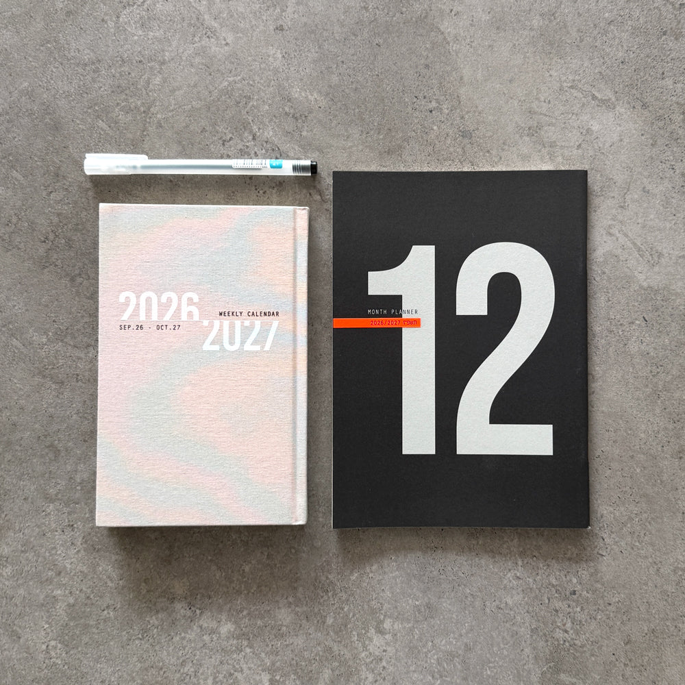 KaRiniTi Year Plan 2026/2027 – pastel-cover weekly calendar and black 12-month planner with white hexagon gel pen