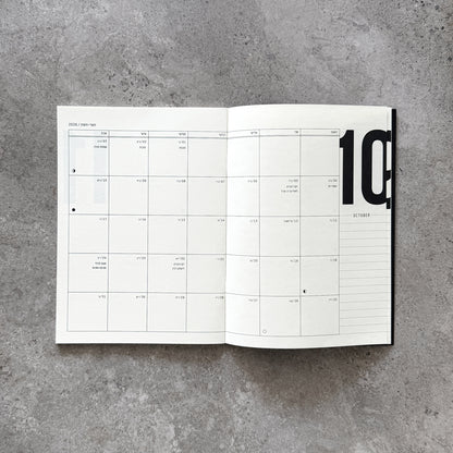 12-Month Planner open on a monthly spread with Hebrew and Gregorian dates