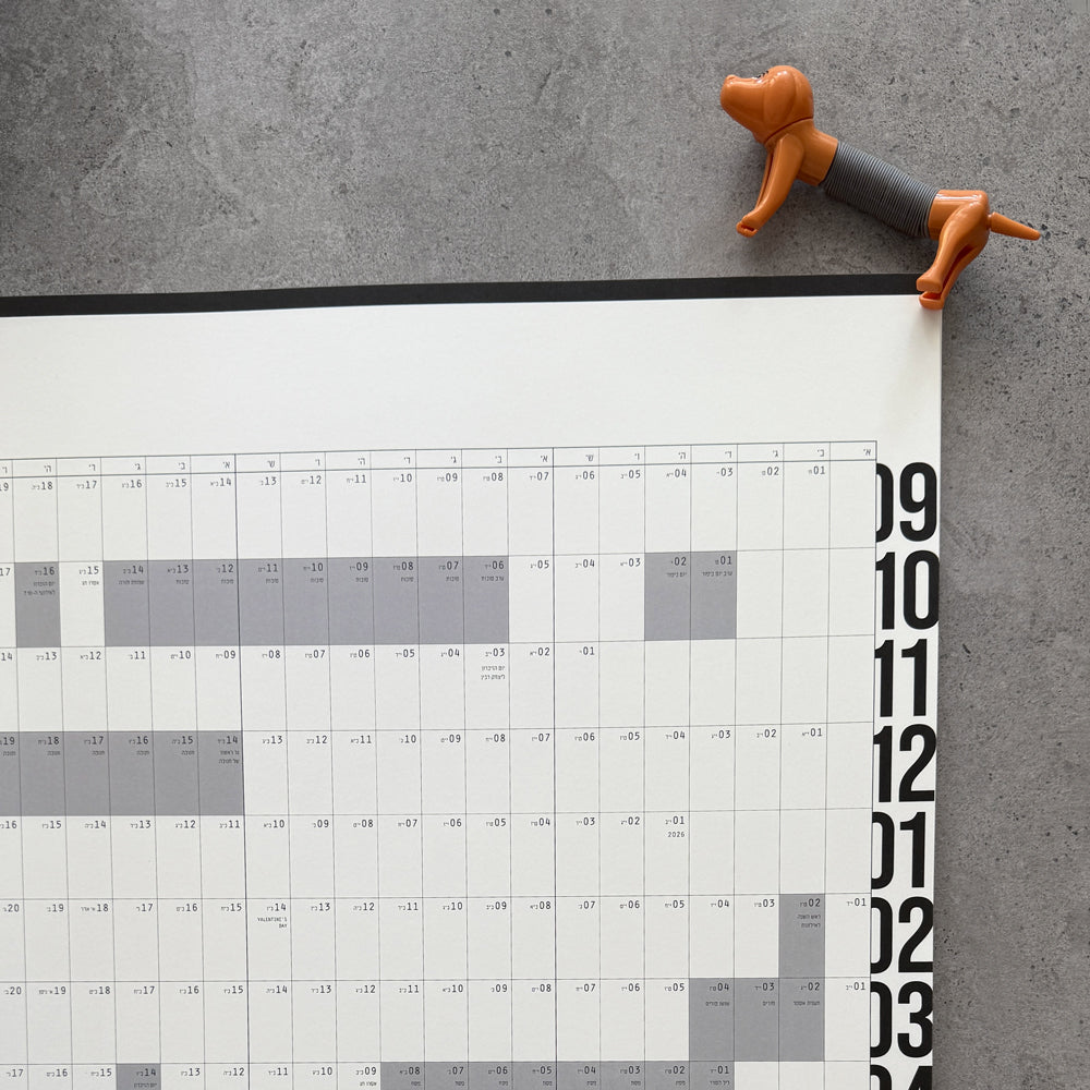 KaRiniTi 365 Day Yearly Planner – top corner detail with orange dachshund pen clip, months 9 through 3 annual grid visible