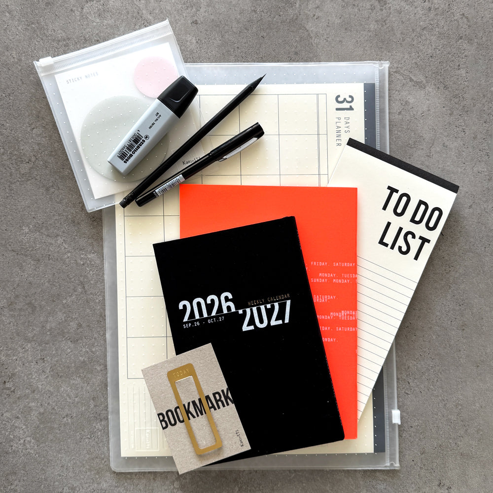 KaRiniTi Deluxe 2026/2027 – black weekly calendar, 31-day planner, bookmark and pens packed inside large transparent zip case