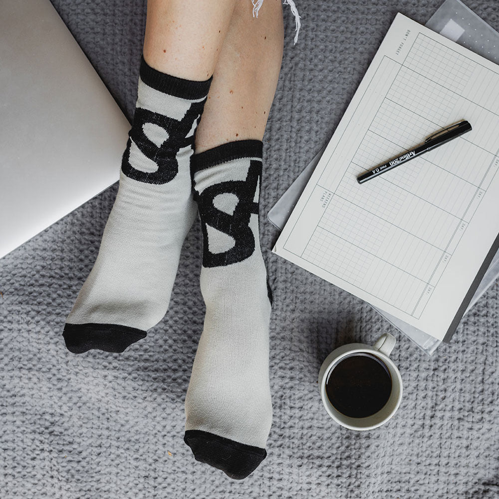 Elevate your everyday style with our elegant unisex socks designed by the KaRiniTi Studio. These monochromatic socks blend clean lines with subtle, refined details, echoing our passion for precision and typography. Perfect for any outfit, each pair brings a unique design element inspired by our studio's signature obsession with structured layouts and minimalist aesthetics.

ASAP: Make a statement with the ASAP socks, reflecting the dynamic energy of KaRiniTi's ASAP notebook. These socks are your fast track 