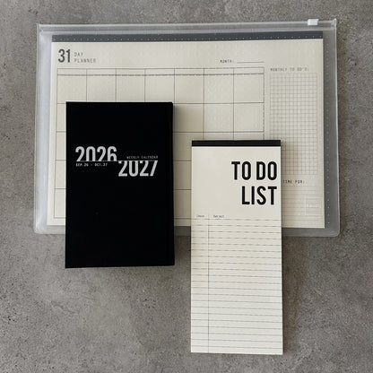 KaRiniTi Super Efficiency 2026/2027 – black weekly calendar, To Do List and 31-day planner in transparent zip case, overhead view