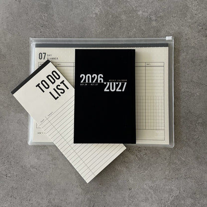 KaRiniTi Super Efficiency 2026/2027 – black weekly calendar, To Do List and 07-day planner packed in transparent zip case, top view