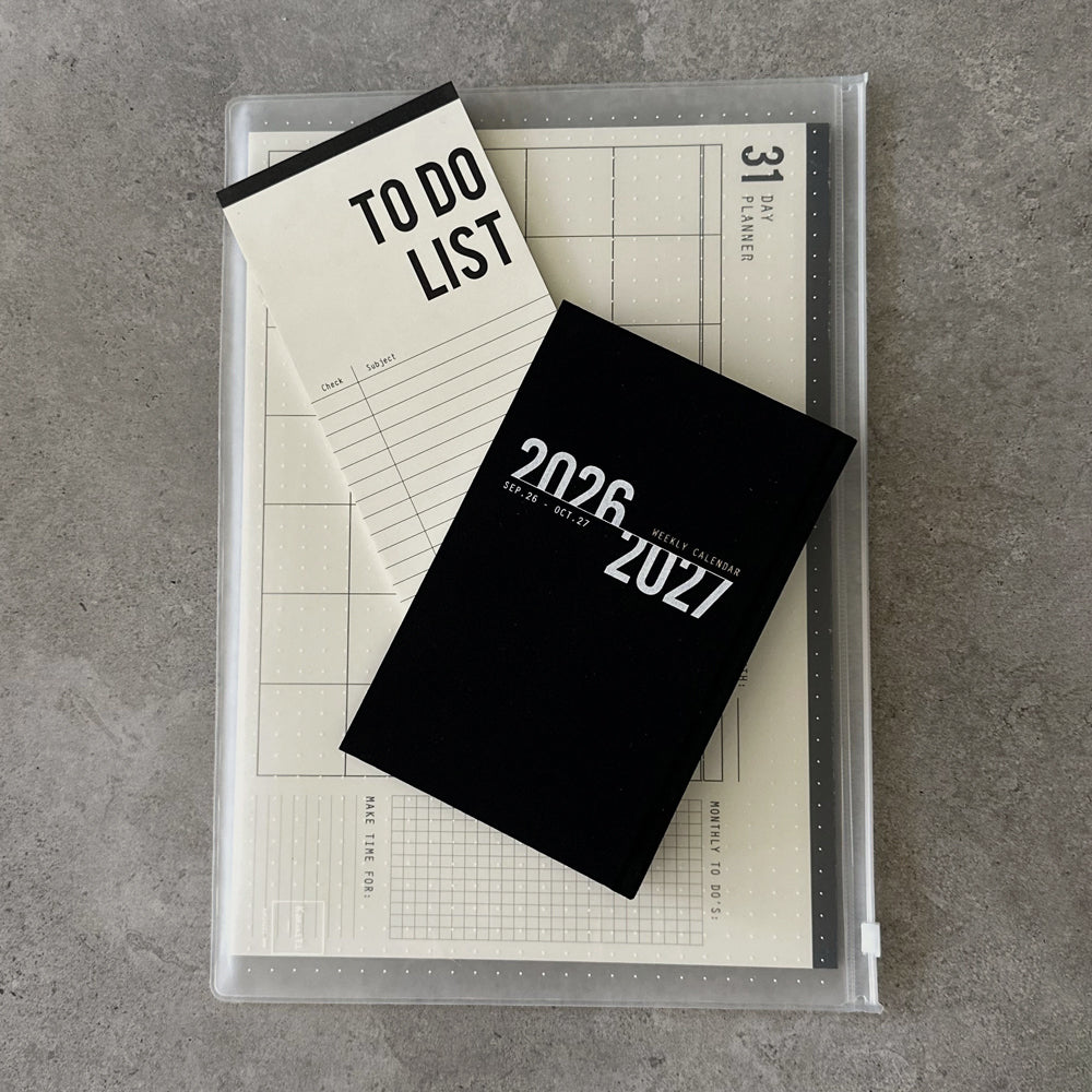KaRiniTi Super Efficiency 2026/2027 – black weekly calendar on top of 31-day planner and To Do List inside transparent zip case
