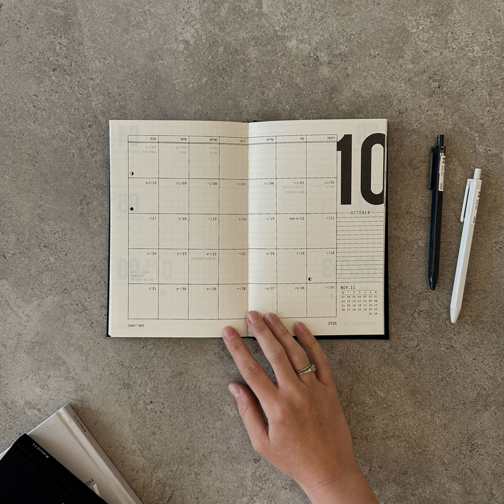 KaRiniTi Weekly Calendar 2026/2027 – open to October 2026 monthly spread with dark blue and white gel pens