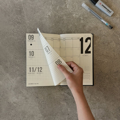 KaRiniTi Weekly Calendar 2026/2027 – hand turning from December weekly to December monthly spread, Stabilo Boss and Artline pen visible