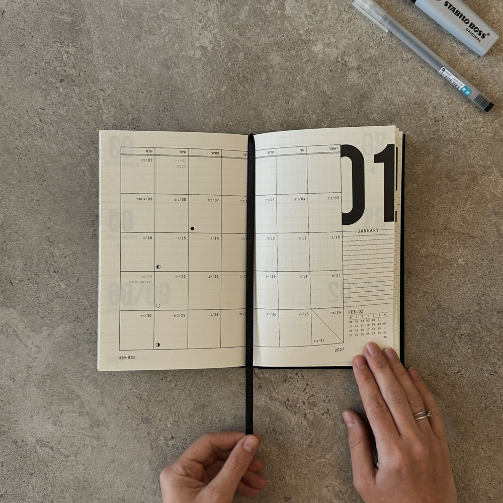 KaRiniTi Weekly Calendar 2026/2027 – open to January 2027 monthly spread, hands holding, Stabilo Boss and Artline pen at top