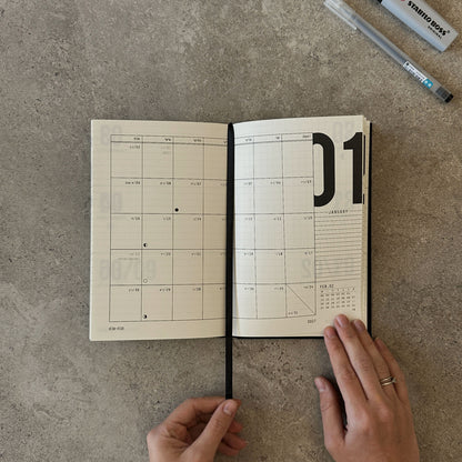 KaRiniTi Weekly Calendar 2026/2027 – open to January 2027 monthly spread, hands holding, Stabilo Boss and Artline pen at top