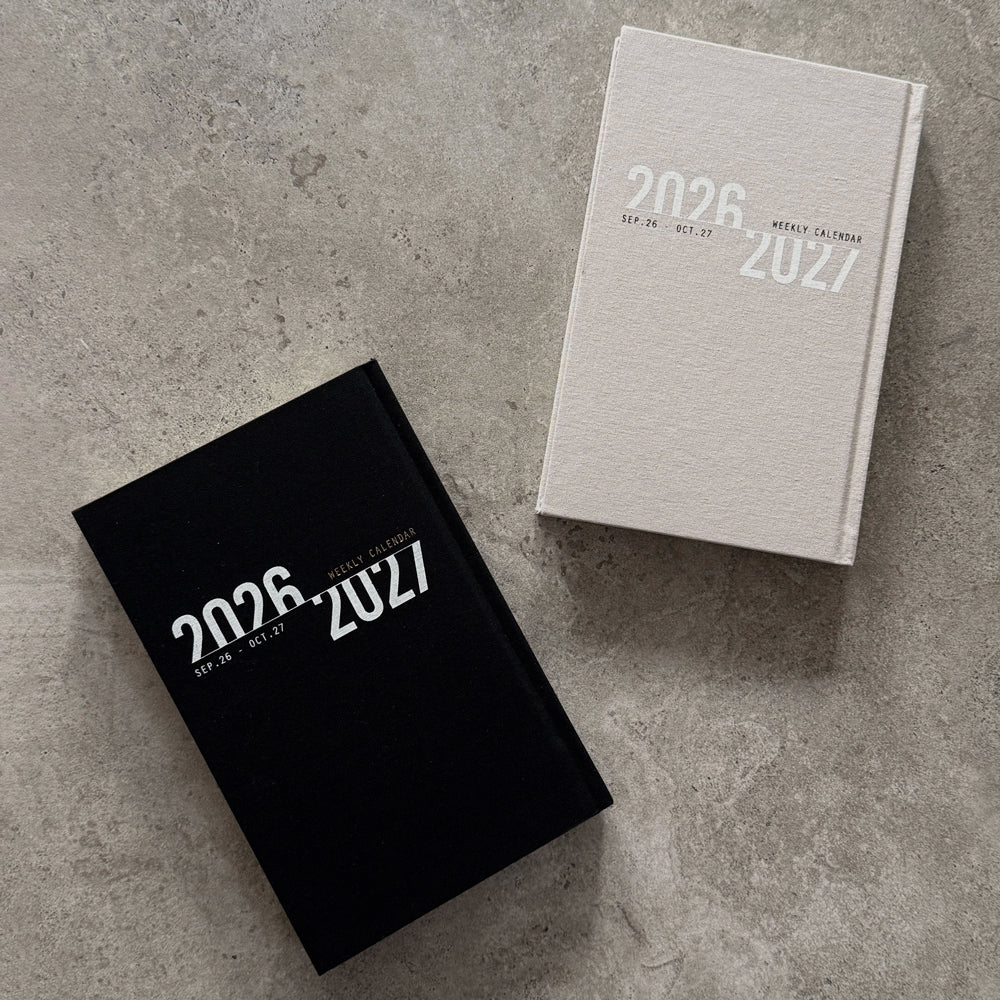 KaRiniTi Weekly Calendar 2026/2027 pair – black and grey covers side by side, Sep 26 – Oct 27